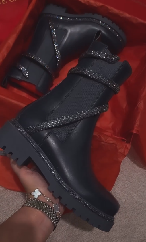 Black diamond sequined stripes wrap around black leather boots